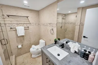 a bathroom with a sink and a toilet and a shower at Steps to the Beach 3BR 2BA Condo Resort Perks and Ocean Glimpse 1406 in Miami Beach