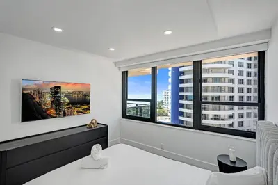 a room with a large window with a view of a city at Miami Beach Paradise 4BR Stylish condo with Resort Perks 1007 in Miami Beach