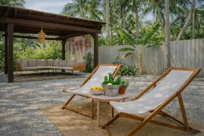 two chairs and a table in a yard at Prime Location Home W BBQ & Free Parking in Miami