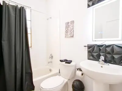 a bathroom with a white toilet and a sink at Cozy 2Bed 1Bath in Edgewater Miami in Miami