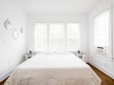 a white bedroom with a large bed and two windows at Cozy 2Bed 1Bath in Edgewater Miami in Miami