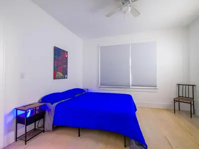 a bedroom with a blue bed and a window at Stylish Miami retreat-Edgewater in Miami