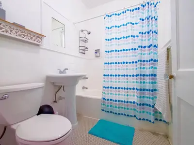 a bathroom with a toilet and a shower curtain at Stylish Miami retreat-Edgewater in Miami