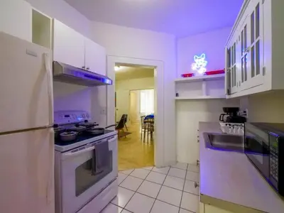a kitchen with white cabinets and a stove top oven at Stylish Miami retreat-Edgewater in Miami