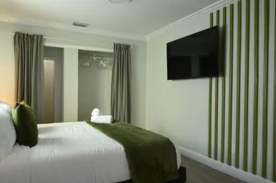 a bedroom with a bed and a flat screen tv at Olympia LUX House 4BR, Heated POOL, BBQ, BAR in Miami