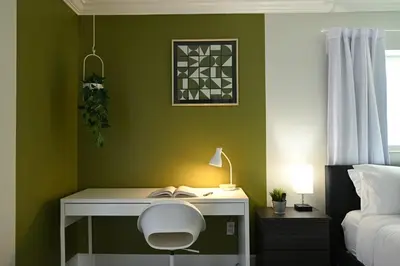 a bedroom with a desk with a chair and a bed at Olympia LUX House 4BR, Heated POOL, BBQ, BAR in Miami