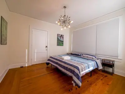 a bedroom with a bed and a chandelier at Central & Stylish Miami Getaway in Miami
