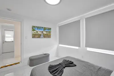 a bedroom with white walls and a bed and windows at Charming 3 bedroom getaway house in Hollywood in Hollywood