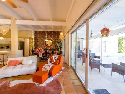 a living room with a couch and a table at 3BD Tropical Luxe Stay with Pool, Gameroom and Grill in Fort Lauderdale