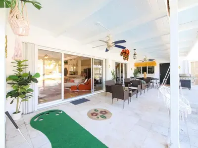 a living room with a ceiling fan and a dining room at 3BD Tropical Luxe Stay with Pool, Gameroom and Grill in Fort Lauderdale