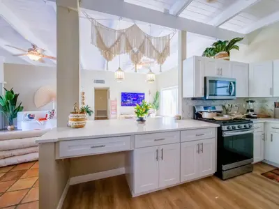 a kitchen with white cabinets and a white counter top at 3BD Tropical Luxe Stay with Pool, Gameroom and Grill in Fort Lauderdale