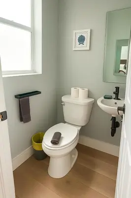 a bathroom with a white toilet and a sink at 2 Beach Units for 6 | Patio + Free Parking in Dania Beach