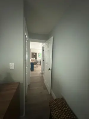 a hallway with a hallway leading to a room at 2 Beach Units for 6 | Patio + Free Parking in Dania Beach