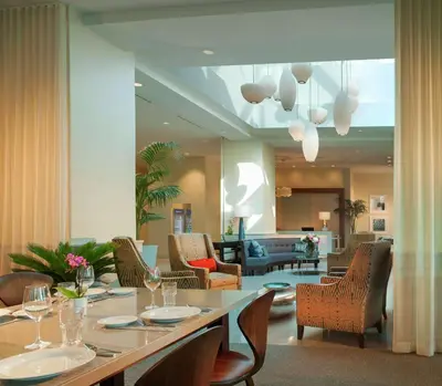 a dining room with a long table and chairs at Hilton Garden Inn Miami Dolphin Mall in Miami