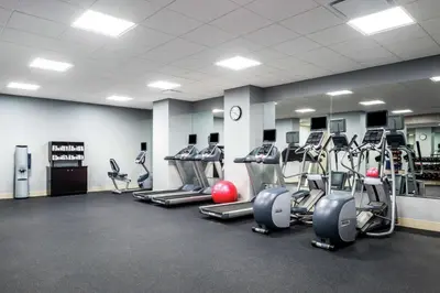 a gym with several treadmills and cardio machines at Hilton Garden Inn Miami Dolphin Mall in Miami