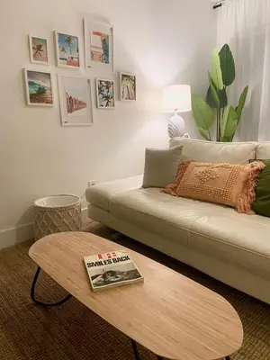 a living room with a couch and a coffee table at 2BD 2BA Bungalow 5 min Dania Beach 15 min Hard Rock Stadium in Dania Beach