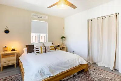 a bedroom with a bed and a ceiling fan at 2BD 2BA Bungalow 5 min Dania Beach 15 min Hard Rock Stadium in Dania Beach