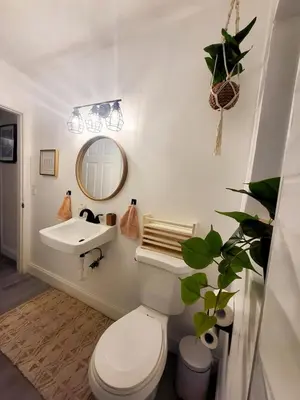 a bathroom with a white toilet and a sink at 2BD 2BA Bungalow 5 min Dania Beach 15 min Hard Rock Stadium in Dania Beach