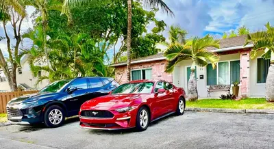 two cars parked in front of a house at 2BD 2BA Bungalow 5 min Dania Beach 15 min Hard Rock Stadium in Dania Beach