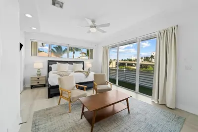 a bedroom with a bed and a large window at Villa Harrison . in Hollywood