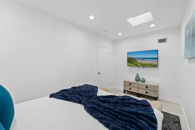 a bedroom with a blue blanket on a bed at Villa Harrison . in Hollywood