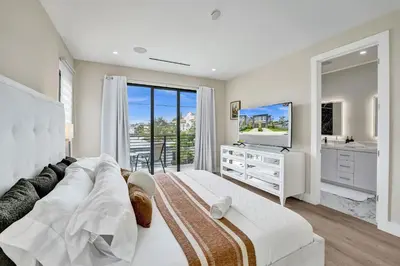 a white living room with a couch and a television at Upscale 4 BDRM Retreat - Mins to Las Olas & Beach in Fort Lauderdale