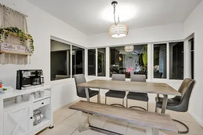 a dining room with a table and chairs at Villa Calma Hidden Tropical Gem with Gym and Pool in Hollywood
