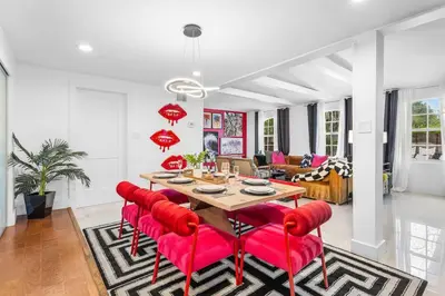 a dining room with a table and red chairs at Luxe 5BR 4BA I Heated Pool 10 Min to Beach I BBQ in Fort Lauderdale