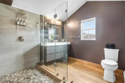 a bathroom with a shower and a toilet and a sink at Luxe 5BR 4BA I Heated Pool 10 Min to Beach I BBQ in Fort Lauderdale