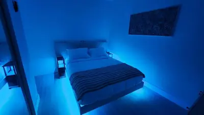 a blue bedroom with a bed in a blue room at Blue Loft305 in Hialeah