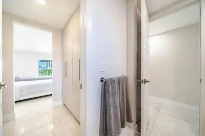 a bathroom with a walk in shower and a glass door at Cozy place near Beachside in Sunny Isles Beach