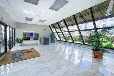 an empty lobby with plants in a building at Cozy place near Beachside in Sunny Isles Beach