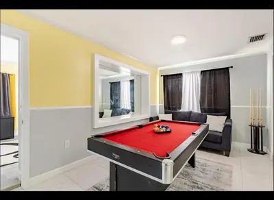 a living room with a pool table in it at Homeaway Haven in Fort Lauderdale