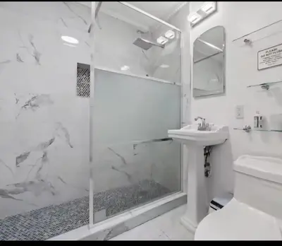 a white bathroom with a shower and a sink at Homeaway Haven in Fort Lauderdale