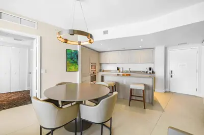 a dining room with a table and chairs in a kitchen at Oceanfront Retreat Steps from Hollywood Beach in Hollywood