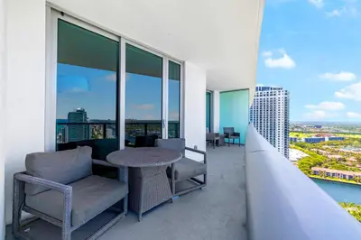 a balcony with a table and chairs on a building at Oceanfront Retreat Steps from Hollywood Beach in Hollywood