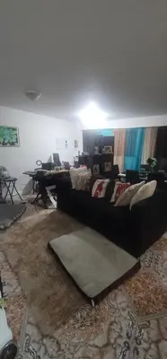 a living room with a couch and a table at Nassau Homestay in Opa-locka