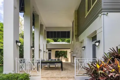a porch of a house with a bench and plants at New Luxe Super Villa by The Glam Homes in Plantation