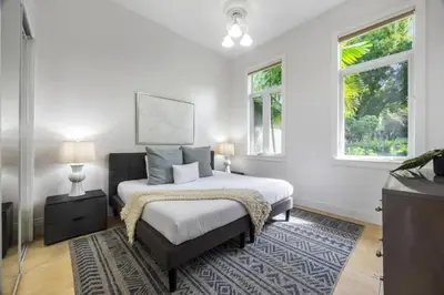 a white bedroom with a bed and two windows at New Luxe Super Villa by The Glam Homes in Plantation