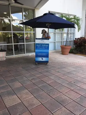 a blue sign under an umbrella on a patio at Ocean Reserve STR-01045 in Miami Beach