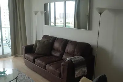 a brown couch in a living room with a mirror at Ocean Reserve STR-01045 in Miami Beach