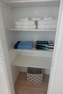 a white closet with towels and towels on a shelf at Ocean Reserve STR-01045 in Miami Beach