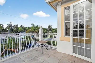 a balcony with a table and a window at Hollywood Crest by Rove Travel - Home with Heated Pool in Hollywood