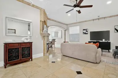 a living room with a couch and a flat screen tv at Hollywood Crest by Rove Travel - Home with Heated Pool in Hollywood