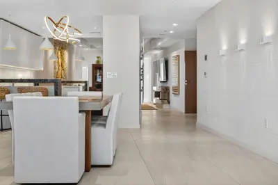 a dining room and living room with a table and chairs at Auberge Blue by Rove Travel Oceanfront with Balcony in Fort Lauderdale