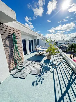 a balcony with a bench on a building at Incredible South Beach Penthouses with private terrace in Miami Beach