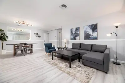a living room with a couch and a table at The Residences at Lake Ridge Apt 1 in Fort Lauderdale