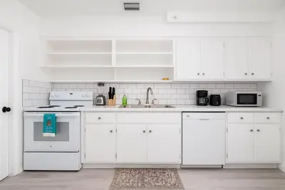 a white kitchen with white cabinets and a sink at The Residences at Lake Ridge Apt 1 in Fort Lauderdale