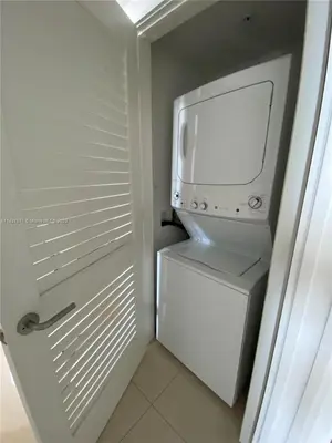 a white refrigerator with a washer and dryer in it at 39th Floor Oceanfront Penthouse with Pool & Gym in Hollywood