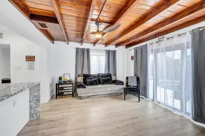 a living room with a couch and some windows at Trendy Waterfront Pool Home Beach Casino Airport in Hollywood